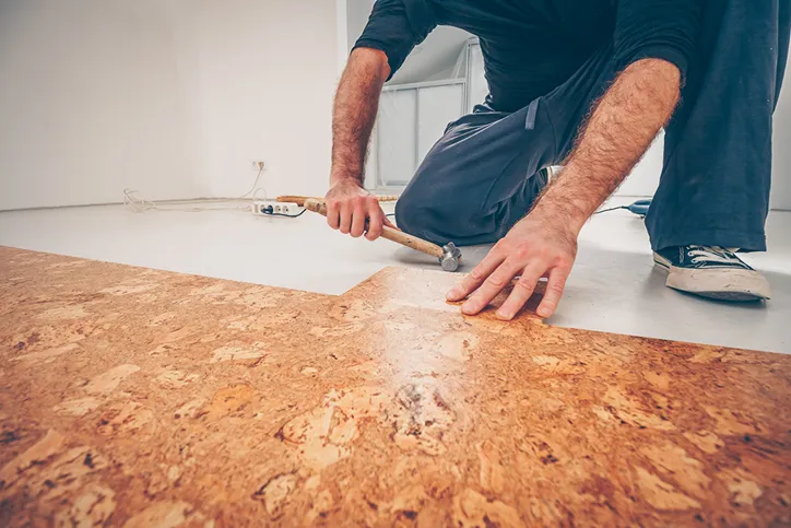 worker laying tile